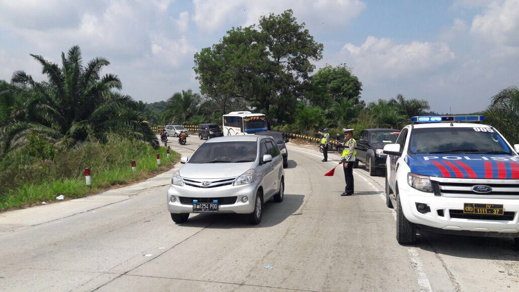 Memberikan kode atau isyarat dengan menggunakan bendera merah kepada pengguna jalan agar tidak memacu kecepatan tinggi 